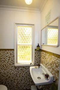 a bathroom with a sink and a window at Swan Cove Beachfront in Raymond Island