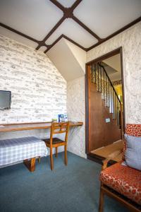 a room with a table and a chair and a staircase at Swan Cove Beachfront in Raymond Island