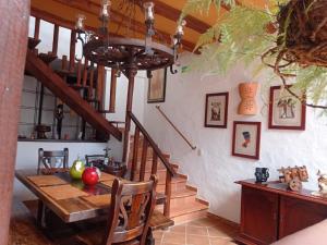 a dining room with a table and a staircase at AQUI ESTOY BIEN in Barichara