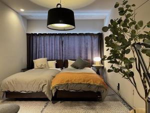 a bedroom with a bed and a potted plant at SAKON UKON in Kanazawa