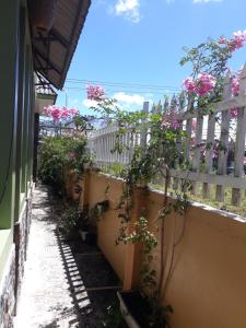 a fence with pink flowers on the side of a building at Dalat Garden Villa in Da Lat