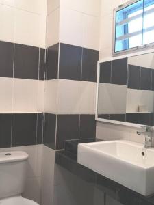 a bathroom with a sink and a toilet and a mirror at W13 atGoldenHills NightMarket WiFi 4R in Brinchang