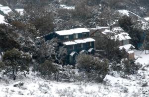 a house is covered in snow on a mountain at Three Bears 2 in Thredbo