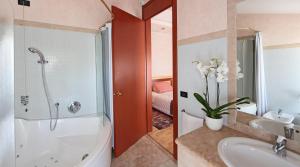 W łazience znajduje się wanna, umywalka i prysznic. w obiekcie Hotel Contà Taste The Experience w mieście Pieve di Soligo