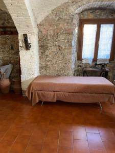 a bedroom with a bed in a brick wall at Casa Lia in Arcola