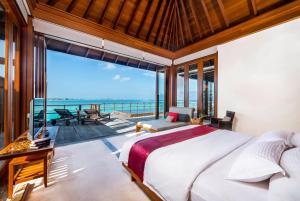 a bedroom with a bed and a view of the ocean at Villa Nautica Paradise Island Resort in Himmafushi