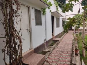 a walkway next to a house with a building at Vatika Homestay in Varanasi