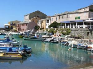 a group of boats are docked in a harbor at AZUREO - Terrasse du golfe in Morsiglia