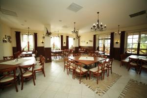 a dining room with wooden tables and chairs at Karczma pod Bażantem in Bramki