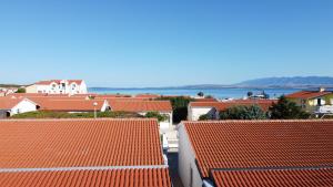 a view of roofs of houses and the water at Apartment Loder in Vir