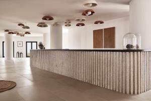 a lobby with a bar in a room at Orama Hotel & Spa in Fira