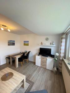 a living room with a table and a dining room at Fehmarn 17-2 in Fehmarn