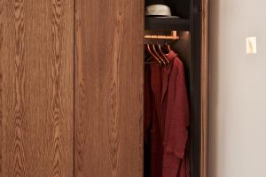 a closet with a wooden door with hangers at Orama Hotel & Spa in Fira