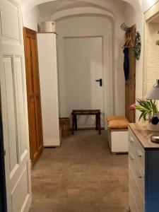 a kitchen with a hallway with a door and a table at Ferienwohnung am Weinberg in Meißen