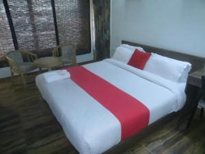 A bed or beds in a room at Hotel Raj Shikhar
