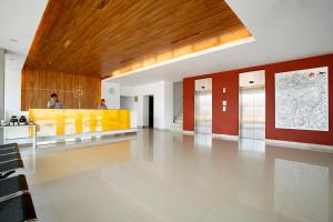 a lobby of a building with people in the background at Amaris Hotel Palembang in Palembang