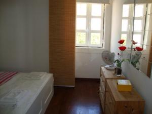 a bedroom with a bed and a window and a table at Simply Bairro Alto in Lisbon