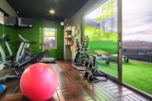 a gym with a large red ball and exercise equipment at Hotel Bed4U Tudela in Tudela
