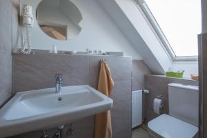 a bathroom with a sink and a toilet at Hotel Strandräuber in Kalifornien +126 photos