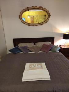 a book sitting on top of a bed with a mirror at Room 23 in Belgrade