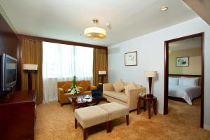a hotel room with a bed and a living room at Liuhua Hotel in Guangzhou