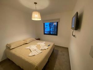 A bed or beds in a room at La Escondida Salta 2