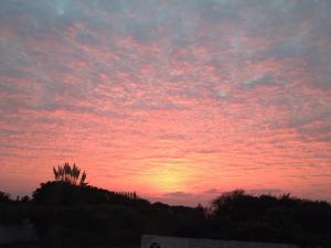 a sunset with a pink in the sky at Apartment 18 Hill View in Brean