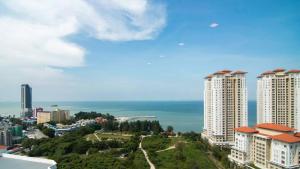 a view of a city with tall buildings and the ocean at Jazz 313 Cosy 2-Bedroom Suite with Pool & Seaview in Bagan Jermal