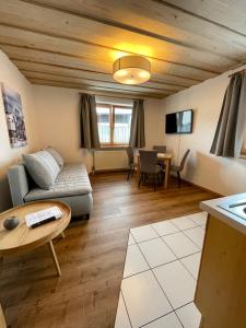 a living room with a couch and a table at Appartment Dörler in Kirchberg in Tirol