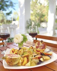a plate of food on a table with two glasses of wine at Esal Hotel in Durrës +13 photos