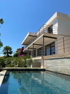 a house with a swimming pool in front of it at El jardin Botánico Villa LUZ in Altea