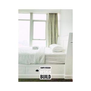 a bed in a bedroom with a sign that reads simulation design build at Thamrin Residences/2BR in Jakarta