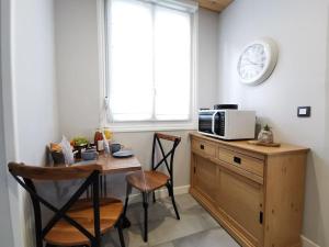 a kitchen with a table and a microwave on a counter at Les bulles d'Ay - Studio in Ay