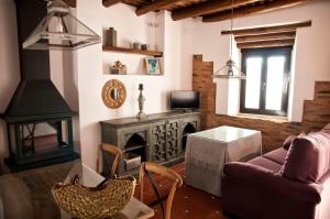a living room with a couch and a fireplace at CR La Cuadra in Constantina