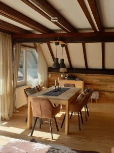 a dining room with a wooden table and chairs at Ferienhaus Chiemgauer Auszeit in Siegsdorf