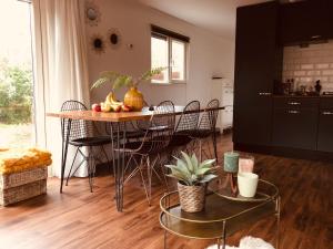 a kitchen with a table with fruit on it at Chalet Bosrand 42 Park Veluwshof 6 p in Hoenderloo
