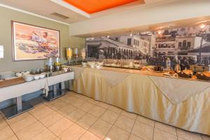 a restaurant with a long counter in a room at Paradise Hotel in Samos