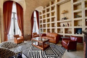 a living room with a couch and chairs and shelves at The Levantine in Marrakesh