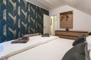 a bedroom with two beds and a wall at Fethy`s House in Brod na Kupi