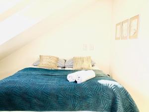 a bedroom with a bed with two towels on it at Syrenka apartament in Darłowo