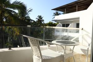 a patio with a table and chairs on a balcony at La Vera Boutique Hotel, Mandrem in Mandrem