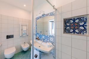 a bathroom with a tub and a sink and a mirror at Sea View Ravello in Ravello