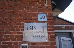 a sign on the side of a brick building at b&b la fabbrica in Gaglianico +4 photos