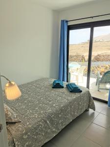 Postel nebo postele na pokoji v ubytování Villaverde Relax 1 a 10 minutos de Corralejo