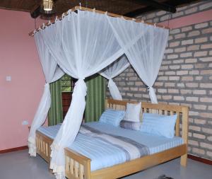 Tempat tidur dalam kamar di Muga Eco Village