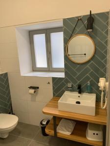 a bathroom with a sink and a mirror at Benátky 214 in Vranov nad Dyjí