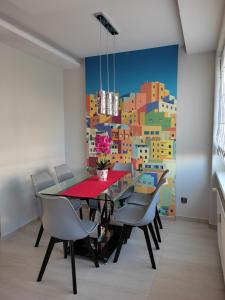 a dining room with a table and chairs at Apartament Red in Olsztyn