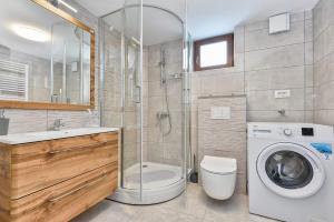 a bathroom with a washing machine and a washer at Holiday home _Oasis of peace_ Varaždin in Ivanec