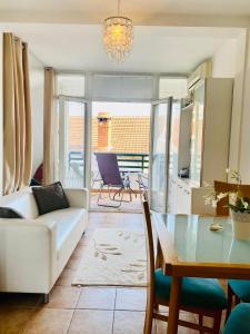 a living room with a white couch and a table at Beachfront two bedroom apartment Angelina in Ðenovići