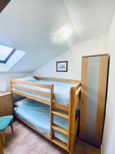 a bedroom with two bunk beds and a desk at Beachfront two bedroom apartment Angelina in Ðenovići